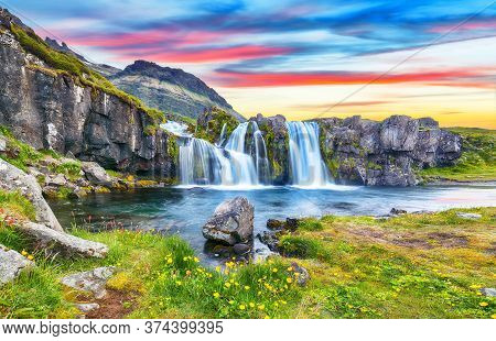 Fantastic View On Kirkjufellsfoss Waterfall  Near Kirkjufell Mountain At Sunset.  Location: Kirkjufe