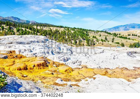 Aerial View Of The Lower Terraces Of Mammoth Hot Springs At Yellowstone National Park With Mount Eve