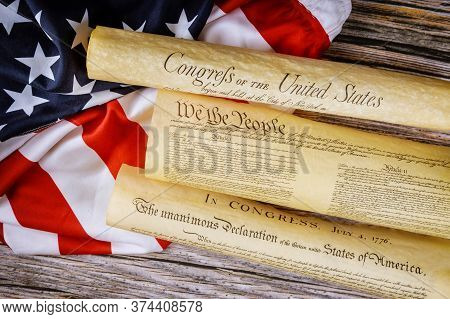 Closeup Of A Replica Of U.s. Document Of American Constitution We The People With Usa Flag.