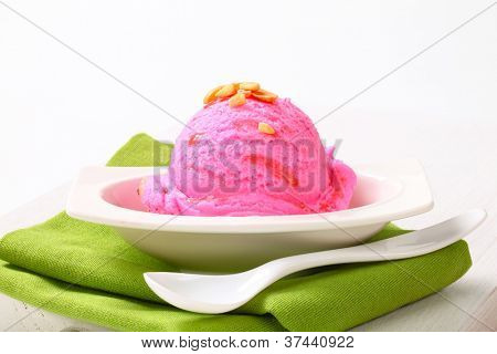 sundae with strawberry ice cream decorated with almond