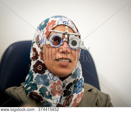 A woman checking her eyes at an ophthamology center
