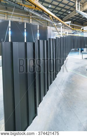 Powder Coating Line. Metal Panels Are Suspended On An Overhead Conveyor Line. Painting Products In A