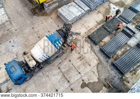 A Concrete Mixer Truck Transports Concrete Through A Construction Site. Transposing Liquid Concrete 