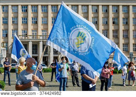 Uzhgorod, Western Ukraine - June 30, 2020: People In Protective Masks Hold Flags Of Trade Unions Of 
