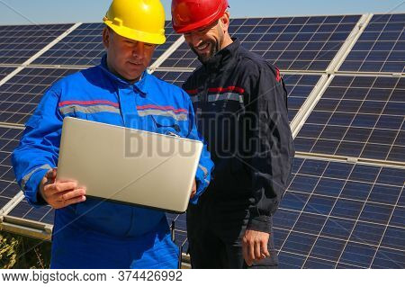 Two Smiling Tehnicians With Laptop In The Power Plant