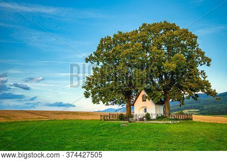 Landscape At Sunset With Chapel Of St. Rochus Above The Village Of Turie Near Zilina Town, Slovakia,