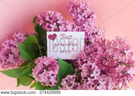 Inscription Best Grandma Ever On A White Gift Card In A Beautiful Spring Bouquet Of Lilac Flowers