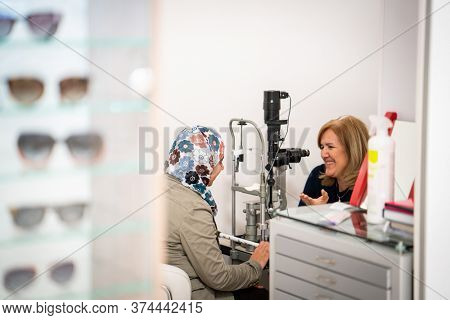 A woman checking her eyes at an ophthamology center