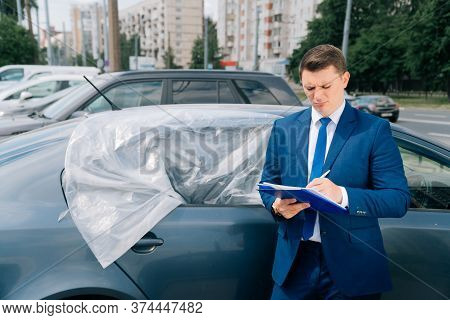 A Man Writes In A Tablet Next To The Car. An Accident On The Road, The Airbag Didnt Work.