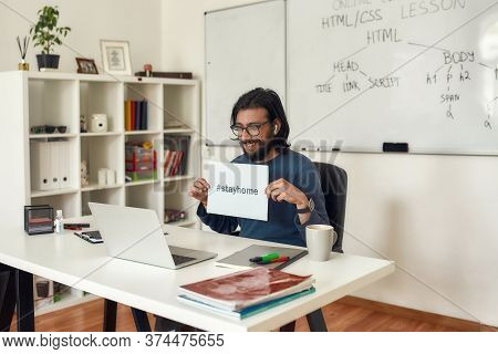 Young Happy Computer Programming Tutor Showing Paper With Text Stay Home At Webcam While Working Onl