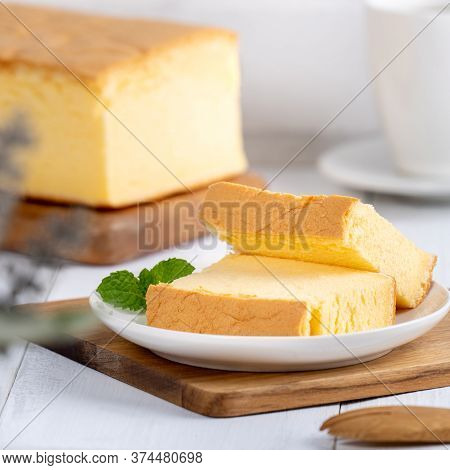 Plain Classic Taiwanese Traditional Sponge Cake (taiwanese Castella Kasutera) On A Wooden Tray Backg