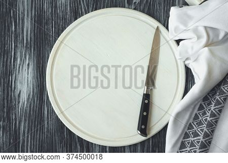 Empty White Cutting Board With Knife On Dark Rustic Background. Flat Lay. Top View. Mock-up