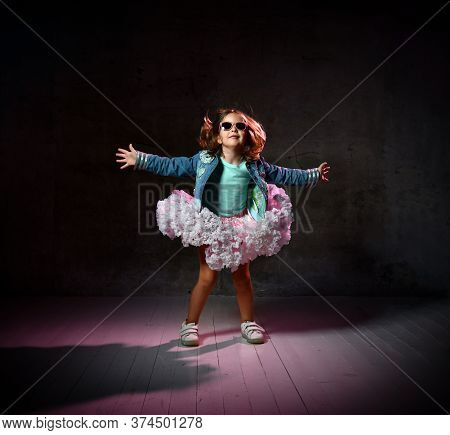 Little Girl In T-shirt, Denim Jacket, Poofy Skirt, Sneakers, Sunglasses. She Spreading Her Arms, Smi
