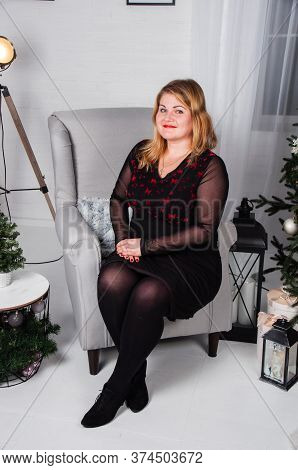 Beautiful, Pretty Woman At Home In The New Year's Interior.