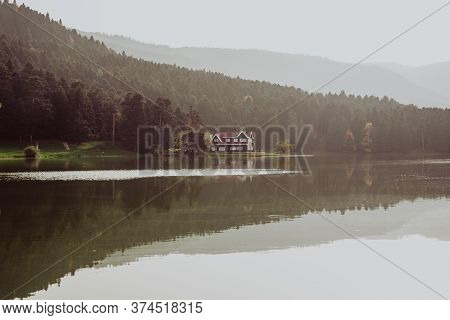 Beautiful Landscape In Autumn With Mountains And Trees Reflecting On A Calm Lake Like A Mirror, Refl