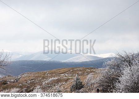 Snowy Landscape Of Bulgarian Mountains. Communist Monument Buzludzha In The Back. Natural Landscape 