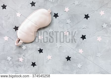 Pink Satin Eye Sleepink Mask And Pink And Sillver Paper Stars Confetti On Gray Background. Sweet Dre