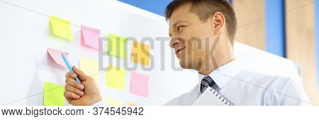 Portrait Of Businesswoman In Presentable Costume Pointing At Note List. Person Holding Clipboard And
