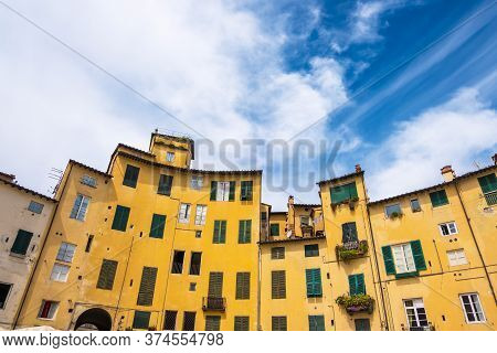 Lucca, Italy - August 14, 2019: Tourists And Locals Visit Ancient Amphitheater Square Or Piazza Dell