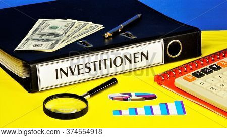 Investitionen-text Label On The Planning Folder. Placement Of Capital For The Purpose Of Obtaining F