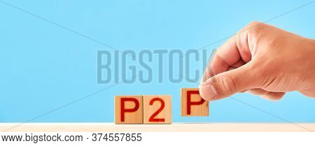 P2p Concept. Man Stacks Wooden Blocks With The Inscription P2p