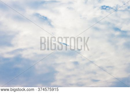 The Sky Is Bright Blue But Overshadowed By White Clouds For The Background.