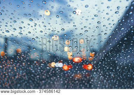 Driving Car On Metropolis Road In Trafic Jam With Raindrop Over The Wind Shield, Rainy Season