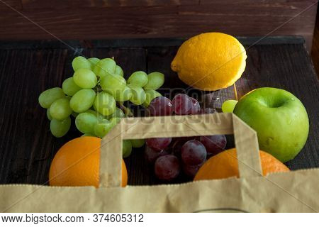Fruits In A Paper Bag. Orange, Lemon, Apple, Grapefruit, Grapes