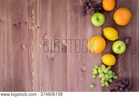 Fruits On The Right Edge Of A Mocha Color Wooden Background