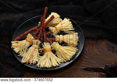 Witches Broom Of Smoked Cheese Suluguni And Salami. Original Idea Halloween Snack.