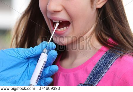 Asymptomatic Little Girl With Long Hair Swabs For Coronavirus