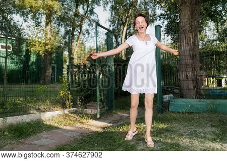 Young Adult Pretty Caucasian Happy Woman In White Dress Having Fun Enjoy Spin And Dancing After Quar