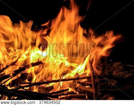 Bonfire On Ivan Kupala.  Bonfire With Branches At Night In The Forest. Tongues Of Fire. Flames Of Fi