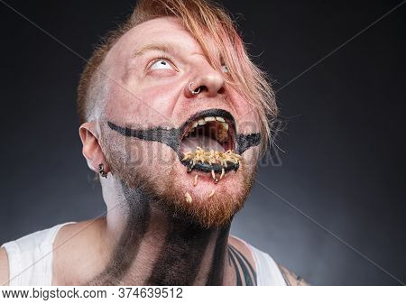 Portrait Of A Scary Mad Man With Maggots In His Mouth