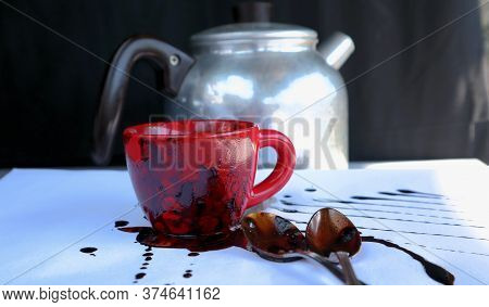 Red Cup with Instant Coffee ,Spoons and a Coffee Pan