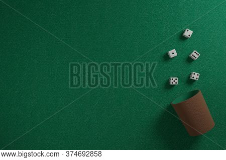 Dice And Dice Cup On A Green Cloth. 3D Illustration.