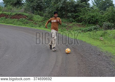 A Boy Playing Football On The Road. 28 June 2020 Mandla Raod Madhya Pradesh,india.