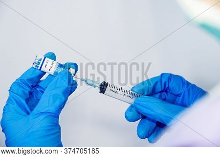 Doctor, Scientist, Researcher Hand In Blue Gloves Or Protective Suit Preparing For Human Clinical In