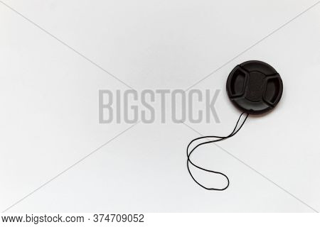 Black Lens Cap Lies On A Brow Background