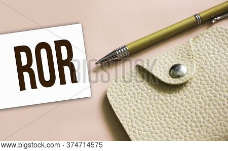 Ror Abbreviation Written On A Business Card, Pen And Beige Leather Wallet. Financial Business Concep