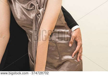 Sexsual Harassment In Workplace. Unhappy Female Employee Looking At Hand Of Boss Touch At Her Hip An