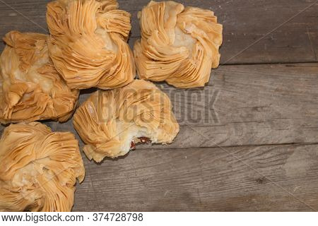 Overhead View Of Fried Sweet Potato And Quince Cupcakes On Rustic Wooden Background