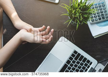 Illness Disease From Office Syndrome Concept. Top View Of Office Worker Massaging Hand And Have Pain