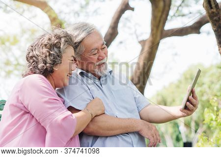 Elderly People Lifestyles And Communication Technology. Happy Grandparent Using Tablet Video Call An