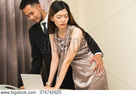 Sexsual Harassment In Workplace. Unhappy Female Employee Looking At Hand Of Boss Touch At Her Hip An