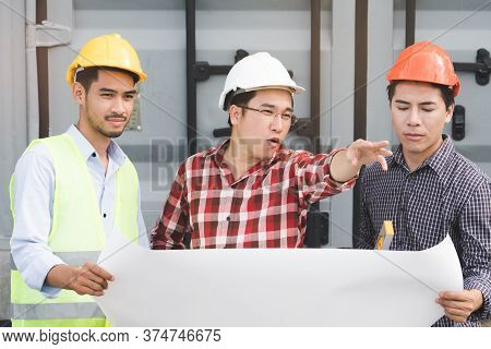 Concept Teamwork Of Building Construction Staff. Project Engineer / Contractor Reviewing Plan Of Wor