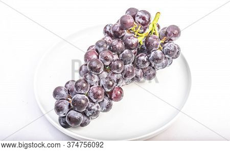 Kyoho Plump Kyoho Grapes (giant Mountain Grapes) Isolated On White In A Dripping Dish, Sweet And Del