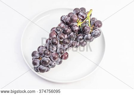 Kyoho Plump Kyoho Grapes (giant Mountain Grapes) Isolated On White In A Dripping Dish, Sweet And Del
