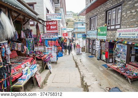 Namche Bazaar, Nepal : October-14-2018 :  The Clothing And Souvenir Shops In The Main Street Of Namc