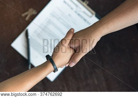 Concept Signing Business Contract, Close Up Above View Of Businessman And Client Shaking Hands After